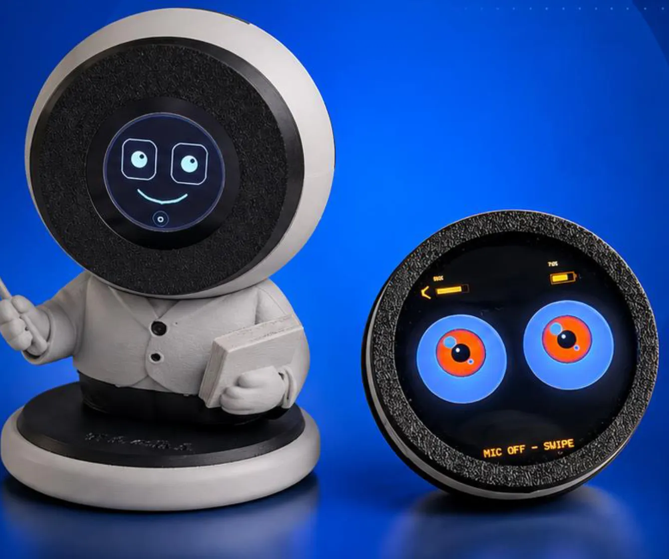 A white 3D-printed Desktop Tichi standing beside the round Pocket Tichi disc on a royal blue background